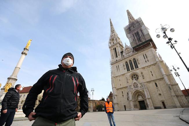 Croatian President Zoran Milanovic is seen in front of a cathedral in Zagreb on March 22, 2020. Two journalists were recently attacked while covering a Mass held against the COVID-19 lockdown in Croatia. (Reuters/Antonio Bronic)