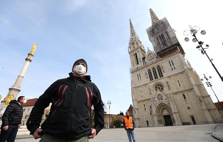 Croatian President Zoran Milanovic is seen in front of a cathedral in Zagreb on March 22, 2020. Two journalists were recently attacked while covering a Mass held against the COVID-19 lockdown in Croatia. (Reuters/Antonio Bronic)