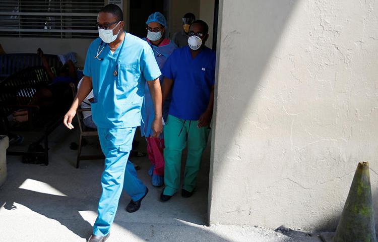 Medical staff are seen in Port-au-Prince, Haiti, on March 27, 2020. CPJ recently spoke with Haitian journalist Robenson Sanon about covering the COVID-19 pandemic. (Reuters/Jeanty Junior Augustin)