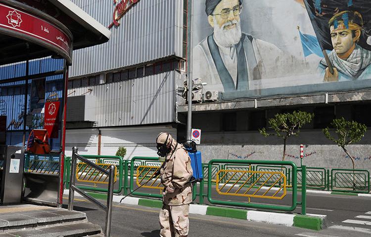 A volunteer sprays disinfectant in Tehran, Iran, on April 3, 2020. Authorities recently detained journalist Gholamreza NoriAlaa over a COVID-19 report. (West Asia News Agency)/Ali Khara via Reuters)