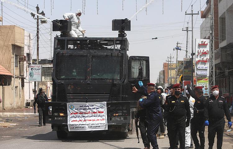 Police officers are seen in Basra, Iraq, on March 31, 2020. Police recently attacked journalist Mohamed Kader al-Samarrai at COVID-19 checkpoint in Samarra. (Reuters/Essam al-Sudani)
