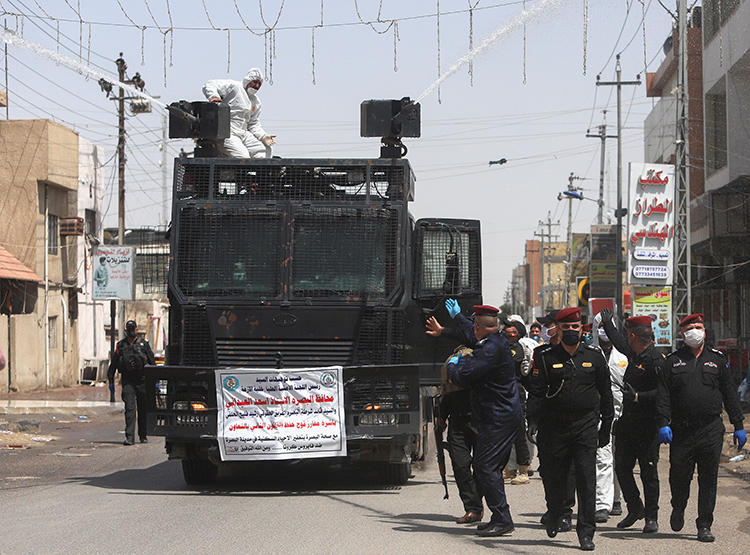 Police officers are seen in Basra, Iraq, on March 31, 2020. Police recently attacked journalist Mohamed Kader al-Samarrai at COVID-19 checkpoint in Samarra. (Reuters/Essam al-Sudani)