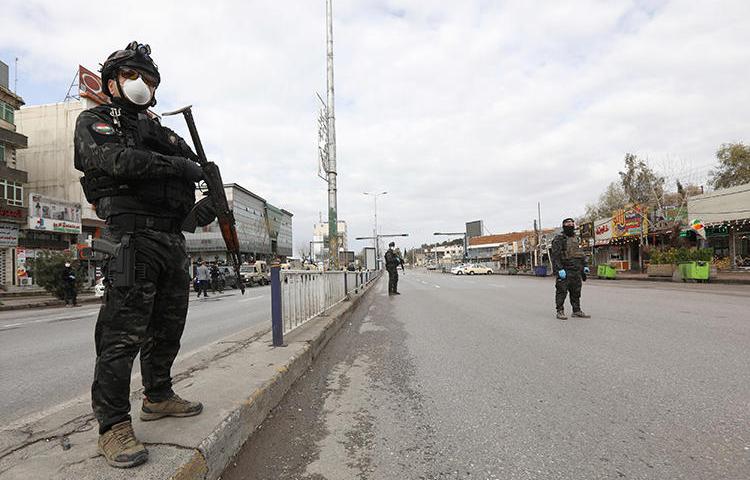 Security agents are seen in Sulaimaniya, Iraqi Kurdistan, on March 14. 2020. Regional authorities recently called for local broadcaster NRT to be closed. (Reuters/Ako Rasheed)