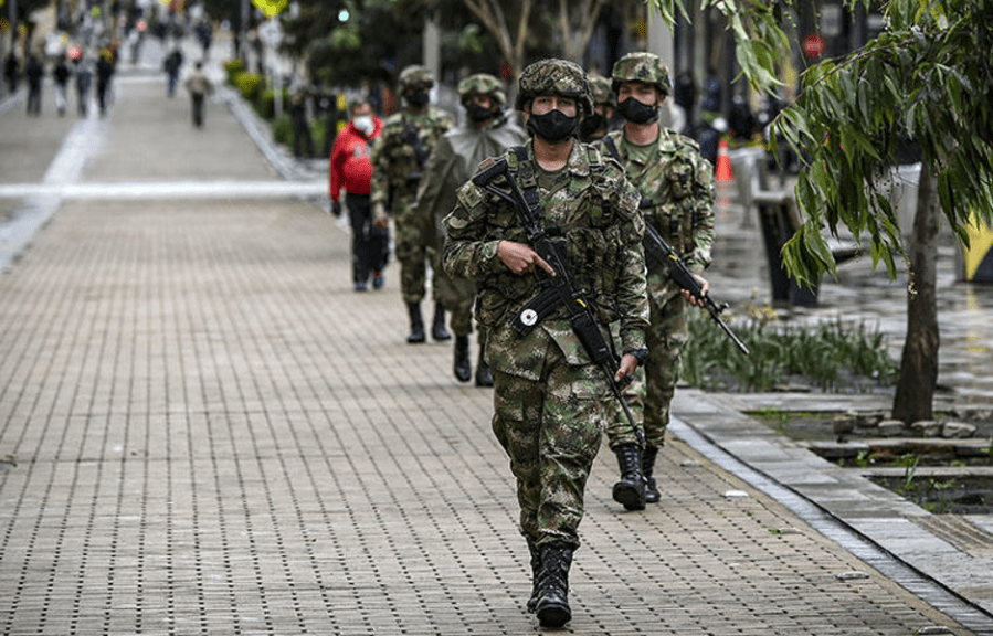 Colombian soldiers wearing masks as a preventive measure against the spread of COVID-19 are deployed on Bolívar Square in Bogotá on April 21, 2020. (AFP/Juan Barreto)