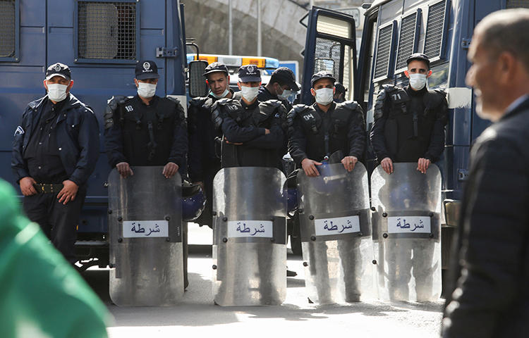 Police officers wearing face masks stand guard during an anti-government protest, following the coronavirus outbreak, in Algiers, Algeria on March 6, 2020. News websites covering both the unrest and the impact of the disease have recently been blocked in the country. (Reuters/Ramzi Boudina)