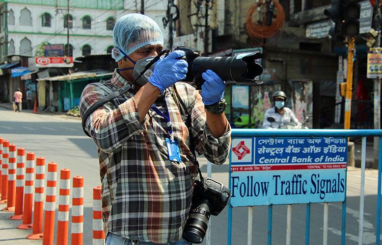El fotógrafo de la AFP, Diptendu Dutta, trabaja durante una cuarentena impuesta por el gobierno como medida preventiva contra el contagio de COVID-19 en Siliguri, en la India, el 10 de abril del 2020. Periodistas freelance han arriesgado sus vidas y su ingreso en el contexto de la pandemia del COVID-19. (AFP)
