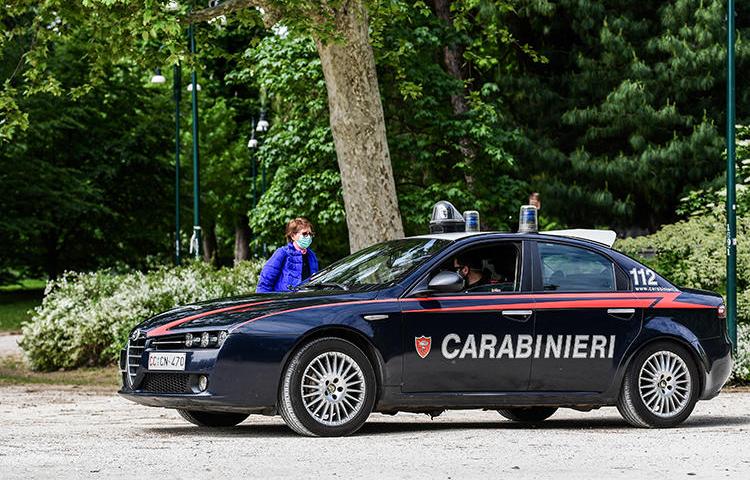 A police car is seen in Milan, Italy, on May 4, 2020. Unidentified attackers recently shot at Italian journalist Mario De Michele’s home. (AFP/Miguel Medina)