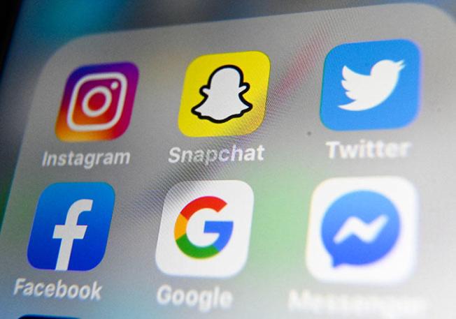 A picture taken on October 1, 2019, shows the logos of mobile apps Instagram, Snapchat, Twitter, Facebook, Google, and Messenger. (AFP/Denis Charlet)