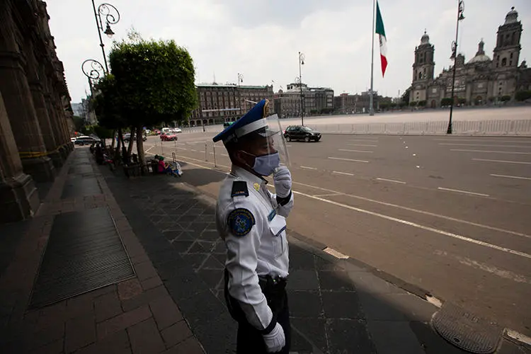A police officer is seen in Mexico City on April 25, 2020. The Mexican Interior Secretariat recently threatened two news companies over their coronavirus coverage. (AP/Fernando Llano)