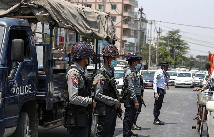 Police officers are seen in Yangon, Myanmar, on April 17, 2020. Editor Khaing Mrat Kyaw is facing terrorism charges and is in hiding. (AP/Thein Zaw)