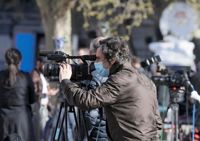 Journalists are seen in London on April 7, 2020. CPJ recently partnered with groups launching surveys to track the COVID-19 pandemic's impact on journalism. (AP/Kirsty Wigglesworth)