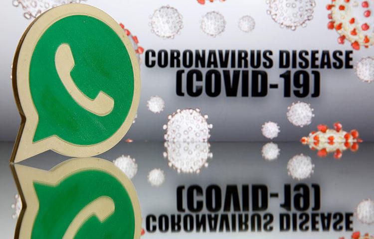 A 3D-printed WhatsApp logo is seen in front of displayed coronavirus disease (COVID-19) sign in this illustration taken March 19, 2020. (Reuters/Dado Ruvic/Illustration)