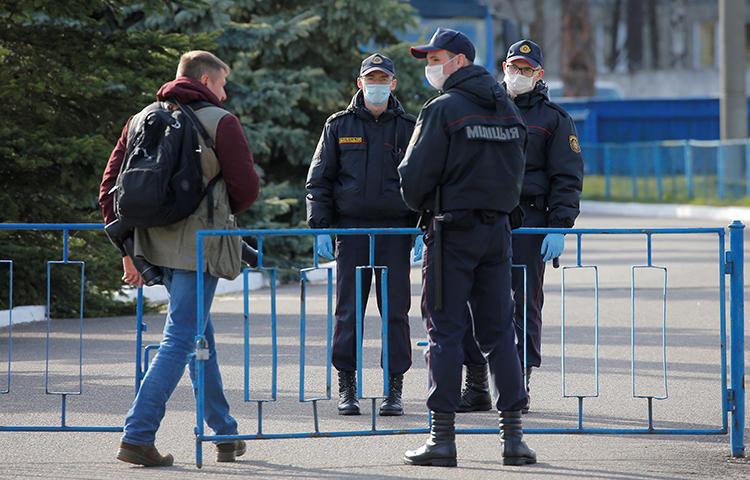 Security guards are seen in Borisov, Belarus, on April 24, 2020. Belarus recently cancelled the accreditations for two journalists covering COVID-19. (Reuters/Vasily Fedosenko)
