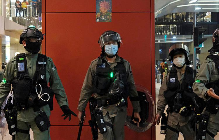 Police are seen in Hong Kong on April 26, 2020. Police recently arrested two journalists for alleged loitering. (Reuters/Tyrone Siu)