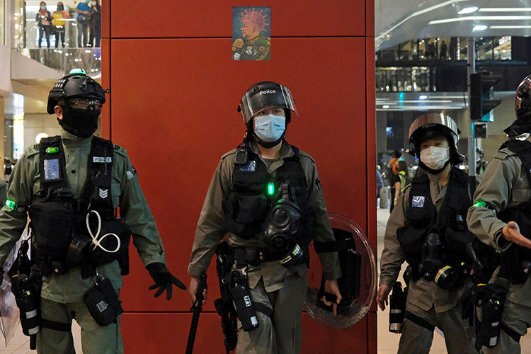 Police are seen in Hong Kong on April 26, 2020. Police recently arrested two journalists for alleged loitering. (Reuters/Tyrone Siu)