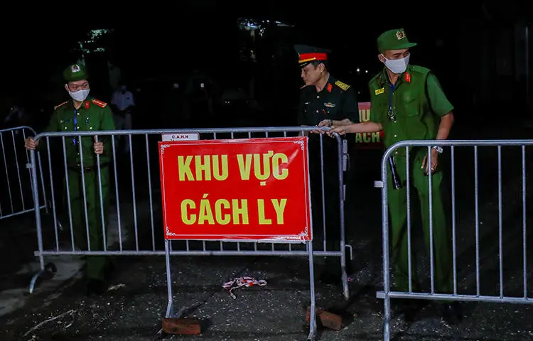 Police and soldiers are seen in Dong Cuu village, outside Hanoi, Vietnam, on May 14, 2020. Hanoi authorities recently arrested journalists Nguyen Tuong Thuy and Pham Chi Thanh. (Reuters/Nguyen Huy Kham)