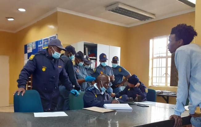 Police officers are seen in the Ficksburg police station. Police recently beat and charged journalist Paul Nthoba after he photographed them enforcing the COVID-19 lockdown. (Photo: Paul Nthoba)
