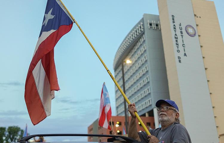 Protesters are seen in front of the Department of Justice in San Juan, Puerto Rico, on July 29, 2019. The department recently subpoenaed Facebook for information from student news outlets on the island. (Angel Valentin/Getty Images via AFP)