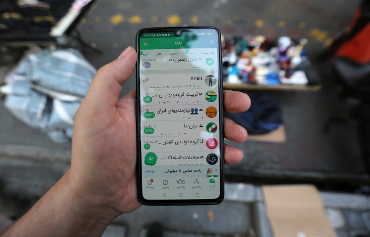 In this picture taken on April 19, 2023, a man shows the Iranian messaging app (Bale) on his mobile telephone in Tehran.