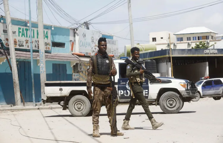 Two armed police officers in fatigues stand guard near the scene of a militant attack in Mogadishu, Somalia August 21, 2022.