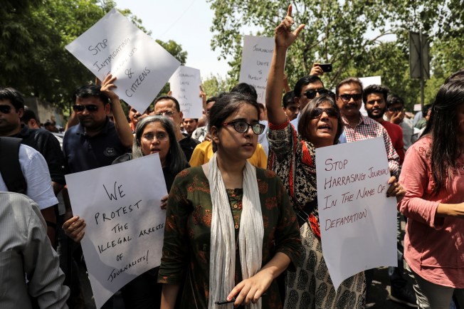 Demonstrators in New Delhi, some with placards protesting over the arrest and harassment of journalists in India.