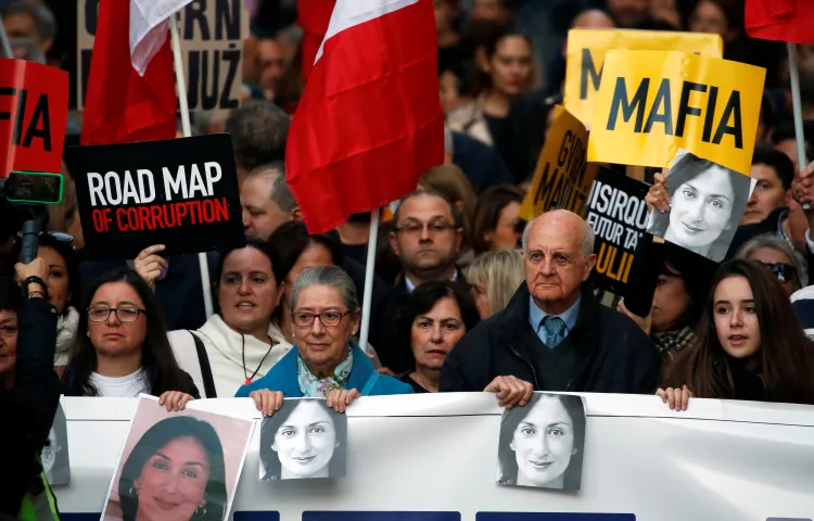 Rose and Michael Vella, parents of late journalist Daphne Caruana Galizia, attend a protest demanding justice over the murder of their daughter and the immediate resignation and investigation of Prime Minister Joseph Muscat in Valletta, Malta, on December 8, 2019.
