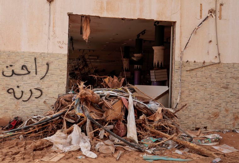Graffiti that reads "Derna is gone" is seen on a damaged shop wall in Derna on September 21, 2023, after a deadly storm hit Libya. (Reuters/Zohra Bensemra)