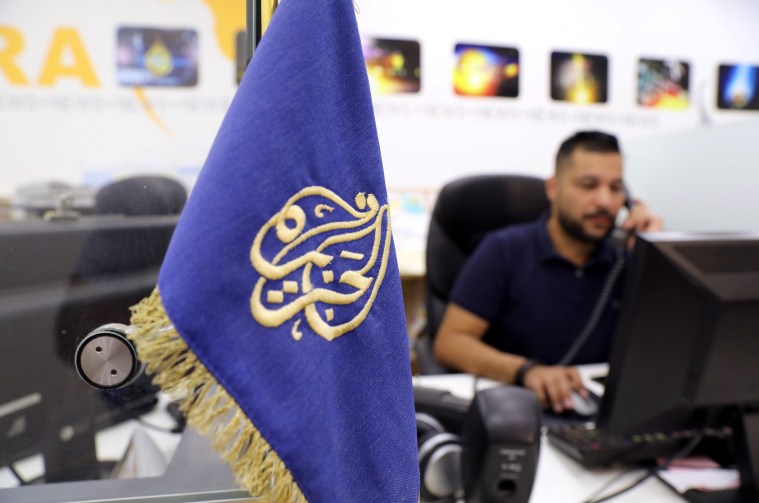 An employee on the phone inside the office of the Qatar-based Al-Jazeera network in Jerusalem on August 7, 2017.