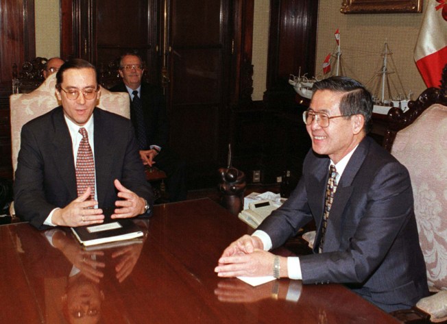 A 1998 photo of Peruvian President Alberto Fujimori (right) with Carlos Ayala, chief of the Inter-American Human Rights Commission. (Reuters)