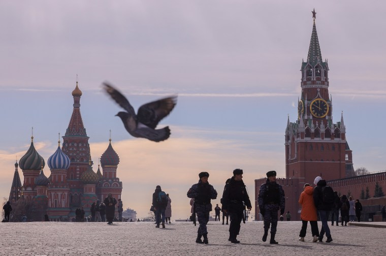 Russian law enforcement officers walk near St. Basil's Cathedral and the Kremlin's Spasskaya Tower on March 20, 2023. (Reuters/Evgenia Novozhenina)
