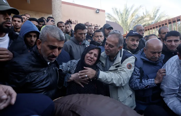 Relatives of Al-Jazeera cameraman Samer Abu Daqqa, who was killed on December 15, 2023, by an Israeli airstrike, mourn his death during his funeral in the town of Khan Younis, southern Gaza Strip, on December 16, 2023. (AP Photo/Mohammed Dahman)