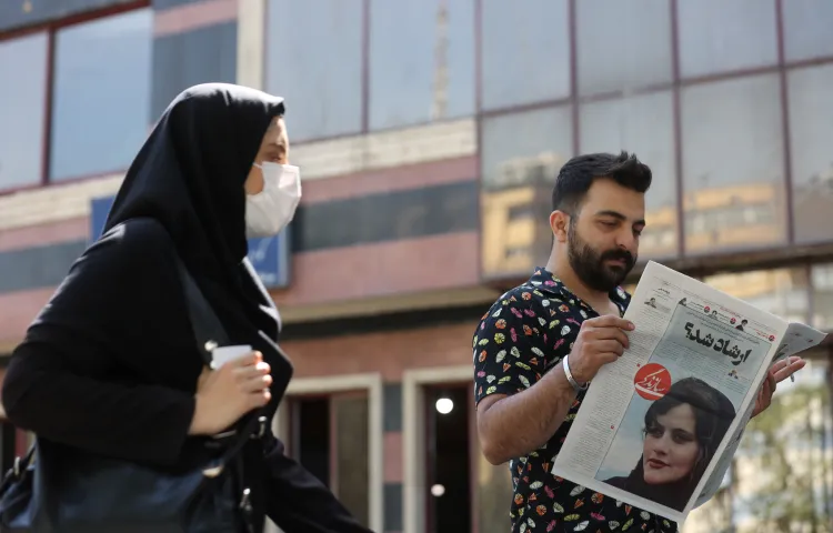 A man reads a newspaper with a picture of Mahsa Amini, who died after being arrested by morality police, in Tehran, Iran, on September 18, 2022.