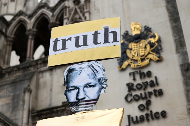 A placard depicts WikiLeaks founder Julian Assange outside the British high court on February 20, 2024 -- the day Assange's lawyers began his final appeal against his extradition to the United States. (Reuters/Isabel Infantes)