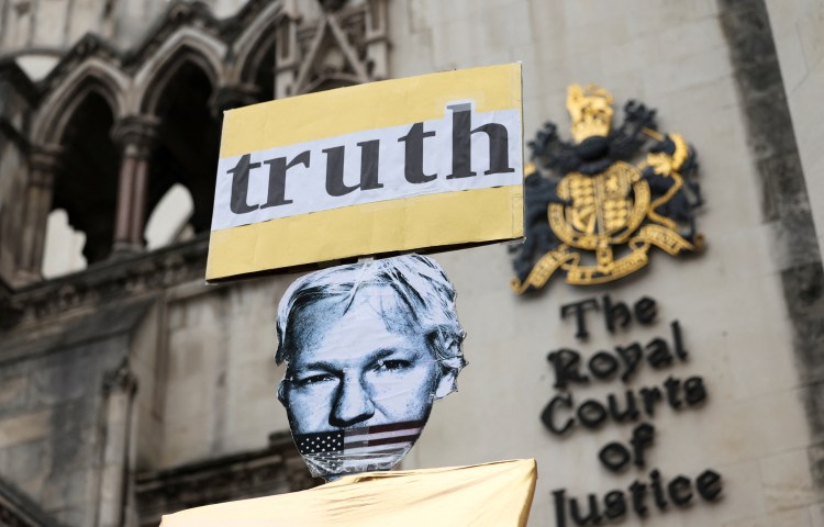 A placard depicts WikiLeaks founder Julian Assange outside the British high court on February 20, 2024 -- the day Assange's lawyers began his final appeal against his extradition to the United States. (Reuters/Isabel Infantes)
