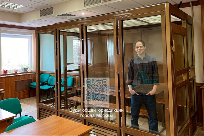 Wall Street Journal reporter Evan Gershkovich stands in a glass cage in Russia's Moscow City Court on March 26, 2024.
