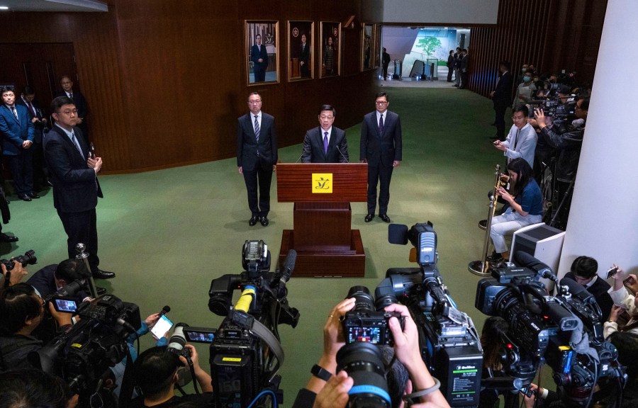 Hong Kong's Chief Executive John Lee (center), Secretary for Justice Paul Lam (center left), and Secretary for Security Chris Tang speak to the media on March 19 about the passing of Basic Law Article 23, which CPJ and other groups say poses a threat to press freedom.