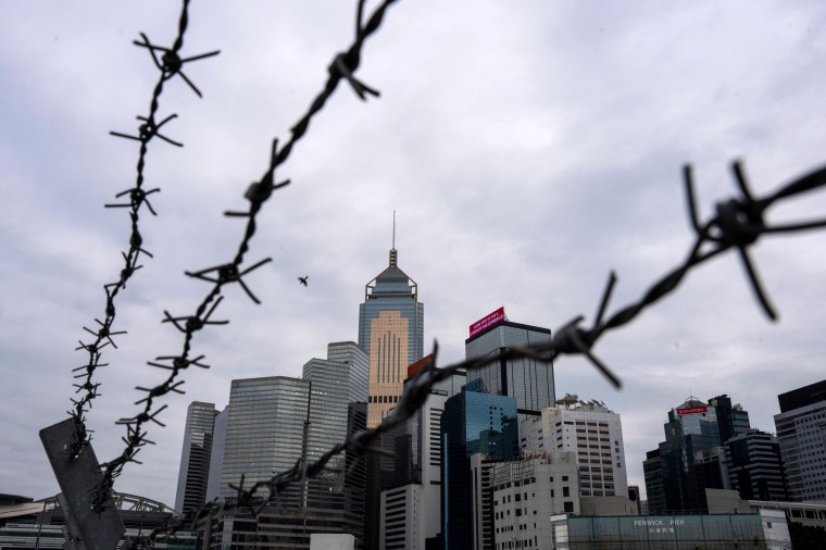 A Hong Kong cityscape is pictured in March 2024 through barbed wire.