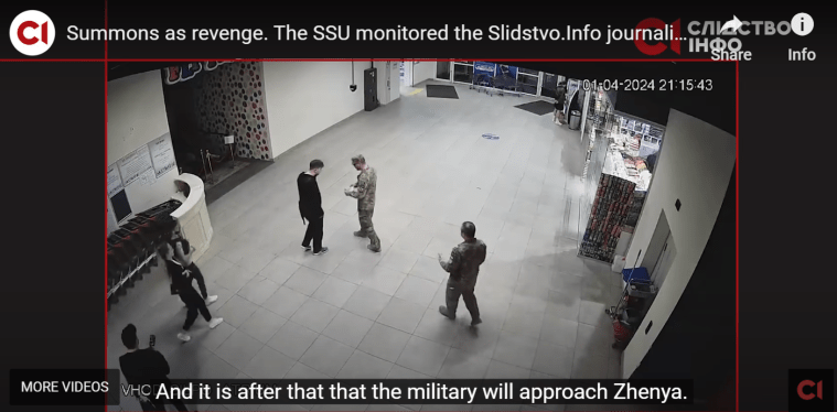 Two Ukrainian military officers speaking with journalist Yevhen Shulhat at a supermarket on April 1. (Screenshot: Slidstvo.Info/YouTube)