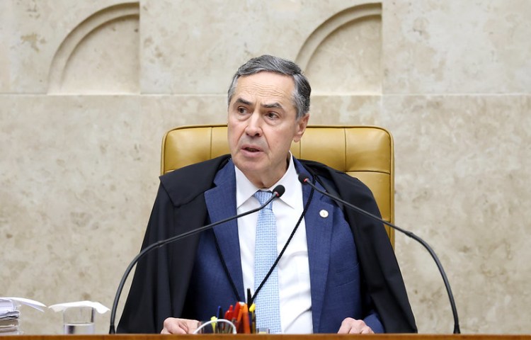 Luís Roberto Barroso, president of the Brazilian Supreme Court, listens to proceedings on May 22, when the court recognized the judicial harassment of journalists.