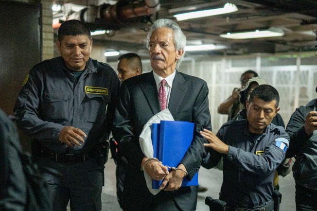 Police escort journalist José Rubén Zamora to court in Guatemala City on June 14, 2023.