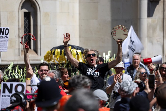 Supporters of Julian Assange celebrate the verdict, outside of the Royal Court of Justice, on the day of an extradition hearing of the WikiLeaks founder, in London, Britain, May 20.