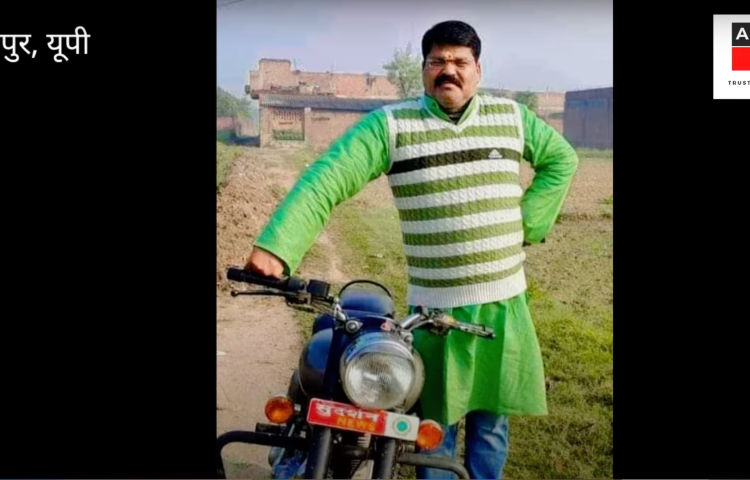 Indian journalist Ashutosh Srivastava standing with a motorbike.