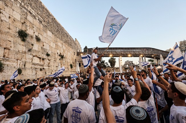 Israeli nationalists, including far-right activists, shout and dance at the Western Wall in the Old City of Jerusalem on June 5, 2024, during the Jerusalem Day Flag March. (Photo: AFP/Gil Cohen-Magen)