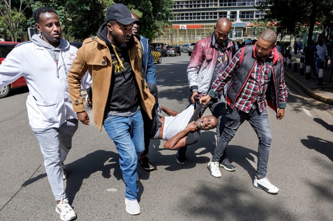 Kenya security officers apprehend an activist protesting the high cost of living before government leaders proceed to the Kenyan Parliament to read the Government's Buget for the 2024/25 fiscal year in Nairobi, on June 13, 2024. Thousands of Kenyans have been protesting a proposed law under the budget that would significantly increase taxes. (Photo: AFP/Tony Karumba)