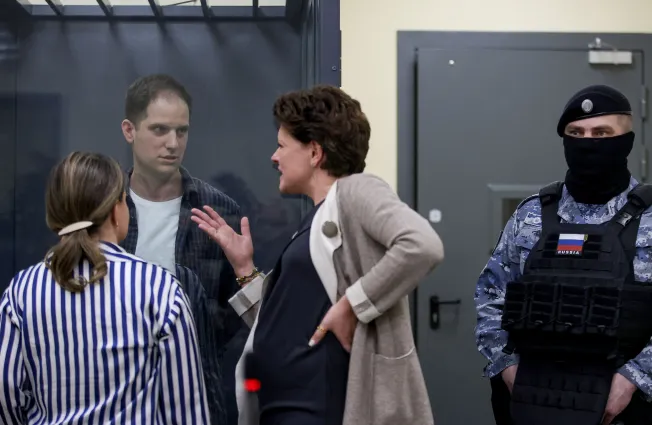 Wall Street Journal reporter Evan Gershkovich speaks with his lawyers before a court hearing in Moscow on April 23, 2024. (Photo: Reuters/Tatyana Makeyeva)