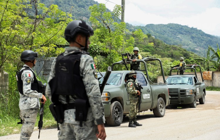 Soldiers keep watch after people fled armed gang violence in Tila, Chiapas state, Mexico, on June 12.