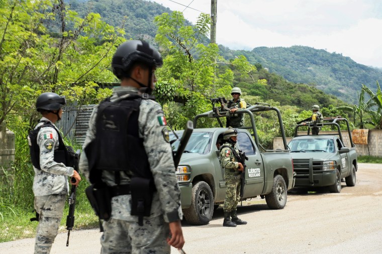 Soldiers keep watch after people fled armed gang violence in Tila, Chiapas state, Mexico, on June 12.