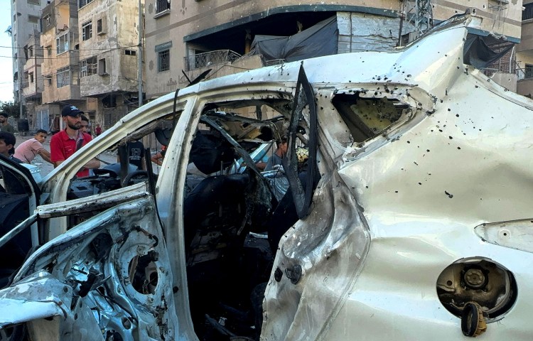 Palestinians inspect the vehicle in which Al Jazeera reporter Ismail Al Ghoul and camera operator Rami Al Refee were killed in an Israeli strike west of Gaza City on July 31, 2024. Israel alleges that Al Ghoul was a Hamas member who took part in the October 2023 raid that started the Israel-Gaza war. (Photo: Reuters/Ayman Al Hassi)