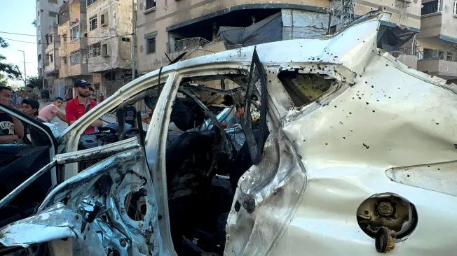 Palestinians inspect the vehicle in which Al Jazeera reporter Ismail Al Ghoul and camera operator Rami Al Refee were killed in an Israeli strike west of Gaza City on July 31, 2024. Israel alleges that Al Ghoul was a Hamas member who took part in the October 2023 raid that started the Israel-Gaza war. (Photo: Reuters/Ayman Al Hassi)