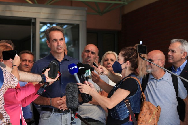 Greek Prime Minister Kyriakos Mitsotakis speaks to journalists in Greece in 2023.